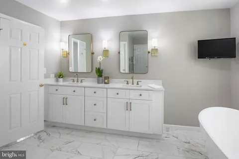 a bathroom with a double vanity sink and a mirror