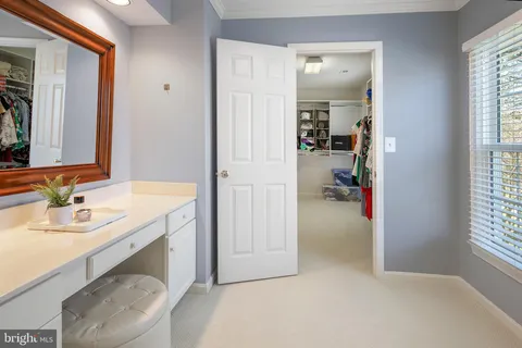 a en suite bathroom with a sink a mirror and next to a window