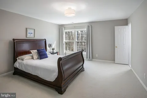 a bed room with a bed and a chair