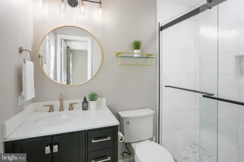 a bathroom with a toilet a sink and a mirror