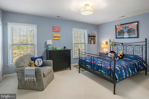 a bedroom with bed and a window