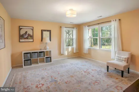 a view of a bedroom with furniture and window