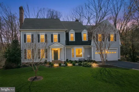 a front view of a house with a garden and yard