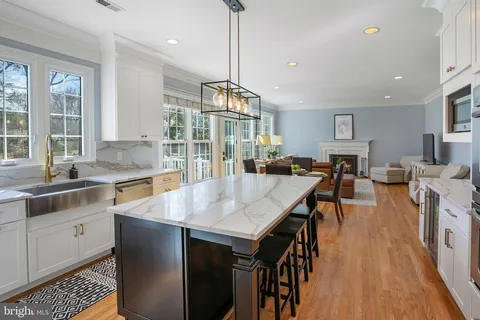 a dining table with chairs and kitchen view