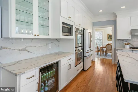 a kitchen with stainless steel appliances a stove a sink and a refrigerator