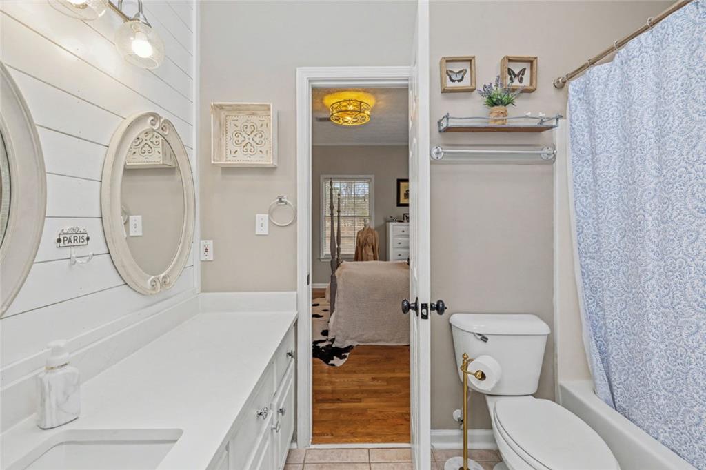 696 Highway 18 Barnesville, GA 30204 - Photo 14 of 57 a bathroom with a granite countertop sink mirror vanity and toilet