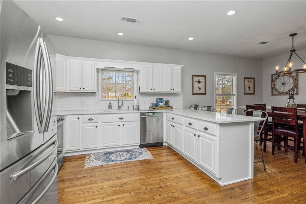 696 Highway 18 Barnesville, GA 30204 - Photo 19 of 57 a kitchen with granite countertop a sink appliances cabinets and counter space
