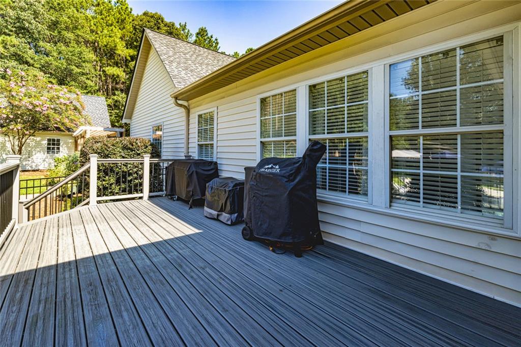 696 Highway 18 Barnesville, GA 30204 - Photo 34 of 57 a view of a deck with table and chairs wooden floor and fence