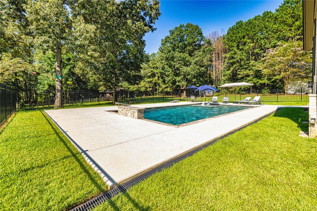 696 Highway 18 Barnesville, GA 30204 - Photo 35 of 57 a view of a backyard with swimming pool