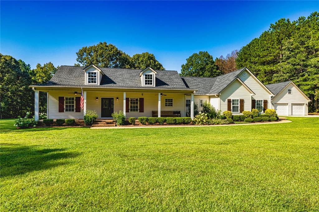 696 Highway 18 Barnesville, GA 30204 - Photo 38 of 57 a front view of a house with a garden