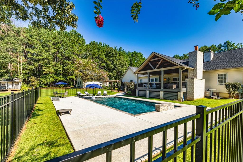 696 Highway 18 Barnesville, GA 30204 - Photo 40 of 57 a view of a house with swimming pool and sitting area