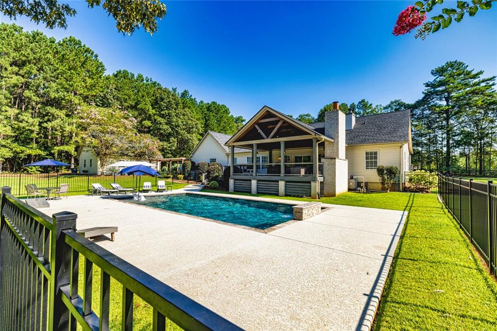 696 Highway 18 Barnesville, GA 30204 - Photo 41 of 57 a view of an house with backyard and a swimming pool