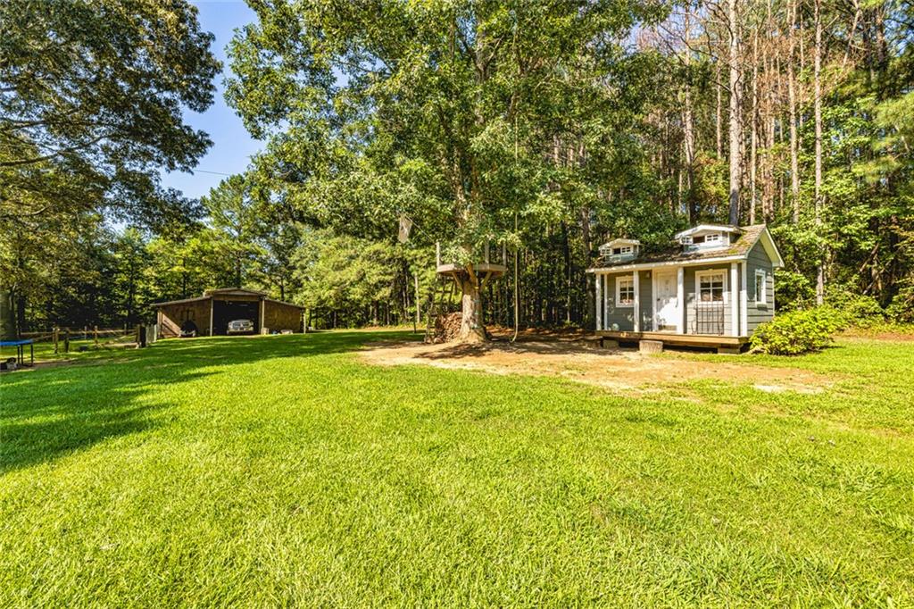 696 Highway 18 Barnesville, GA 30204 - Photo 43 of 57 a front view of a house with a yard table and chairs