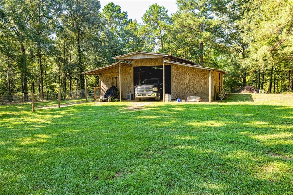 696 Highway 18 Barnesville, GA 30204 - Photo 44 of 57 a view of a house with a yard