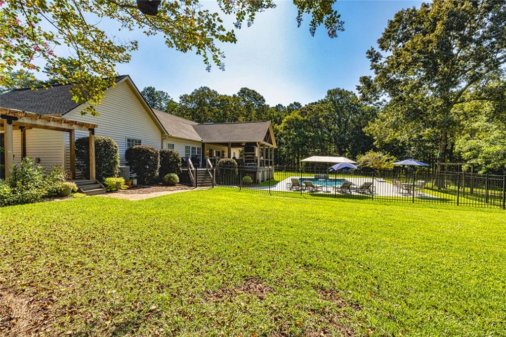 696 Highway 18 Barnesville, GA 30204 - Photo 46 of 57 a house view with swimming pool and garden space