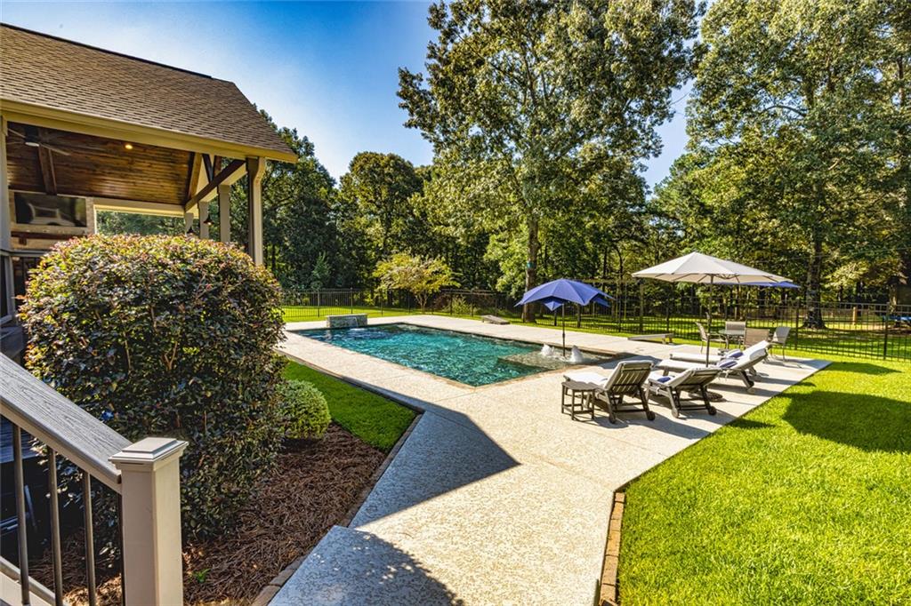 696 Highway 18 Barnesville, GA 30204 - Photo 48 of 57 a view of a swimming pool with a patio and a garden