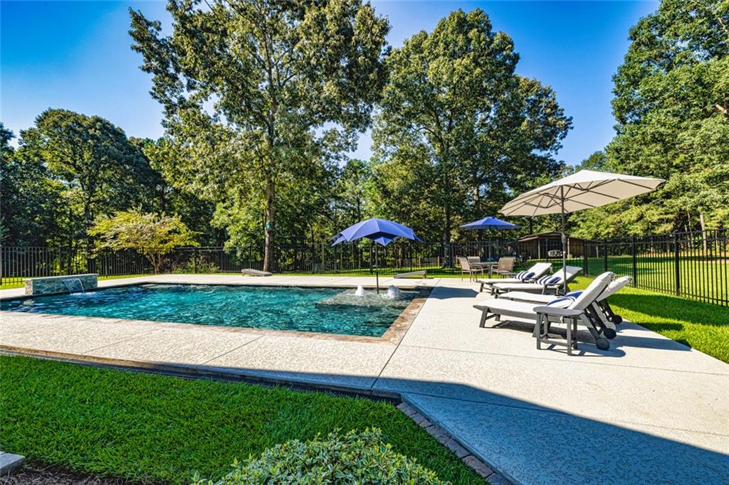 696 Highway 18 Barnesville, GA 30204 - Photo 49 of 57 a view of a patio with a table and chairs under an umbrella
