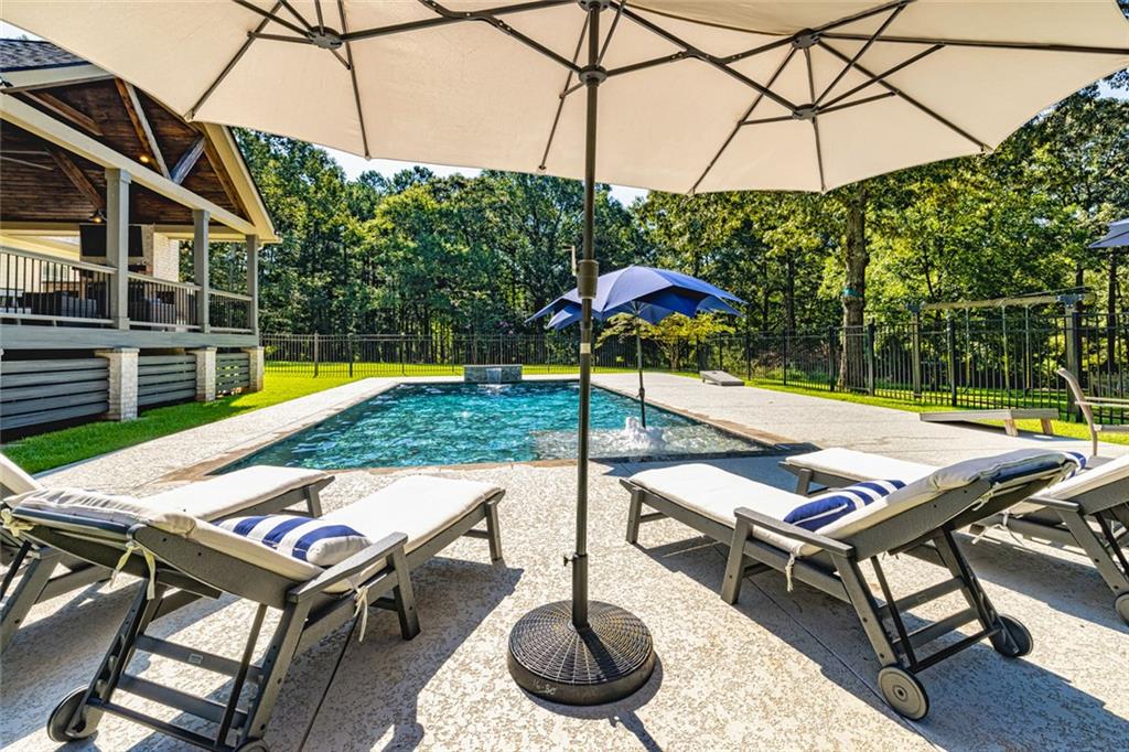696 Highway 18 Barnesville, GA 30204 - Photo 50 of 57 a view of a backyard with swimming pool and sitting area