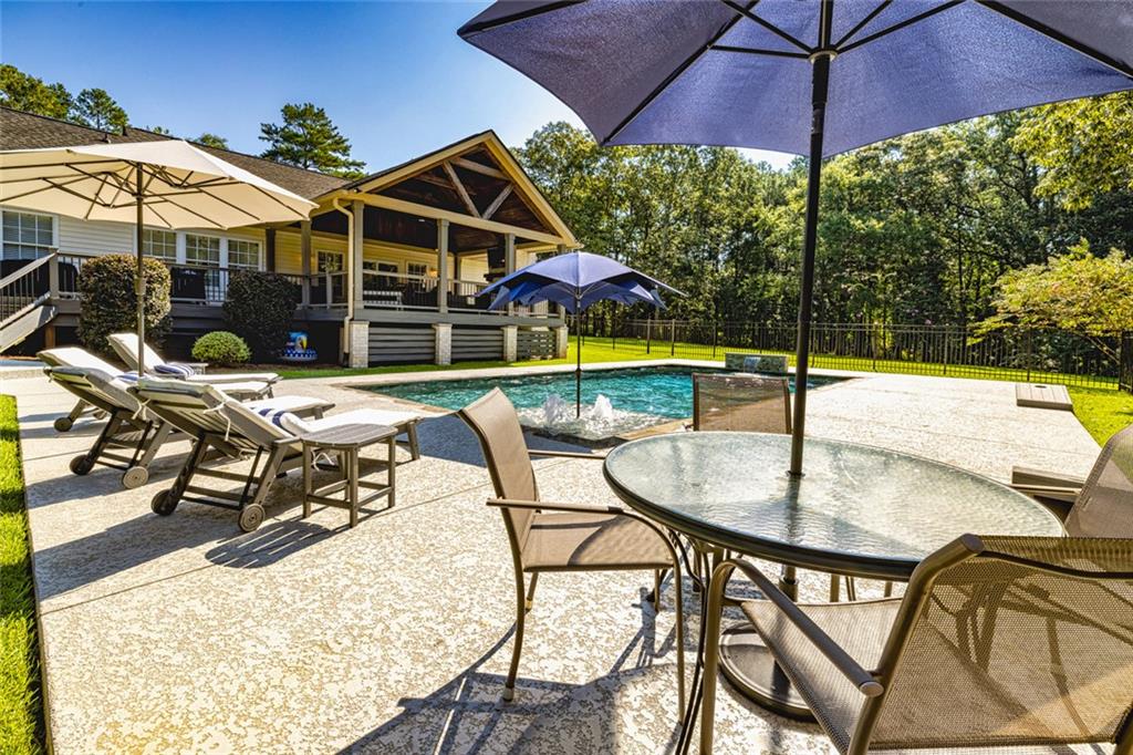696 Highway 18 Barnesville, GA 30204 - Photo 51 of 57 a patio with a patio table and chairs
