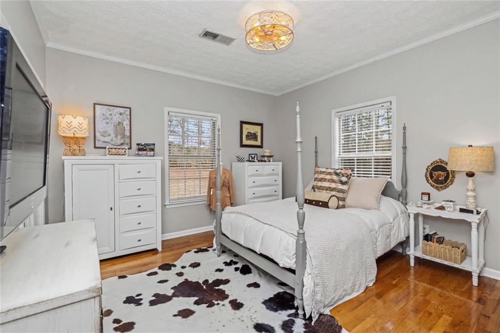 696 Highway 18 Barnesville, GA 30204 - Photo 10 of 57 a bedroom with a bed and a dresser