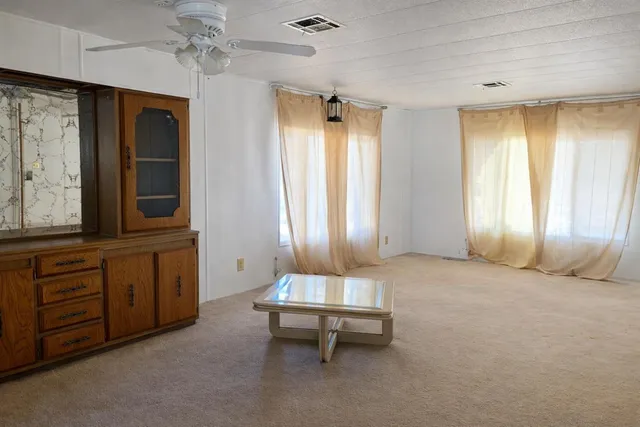 a kitchen with granite countertop a refrigerator stove top oven and sink