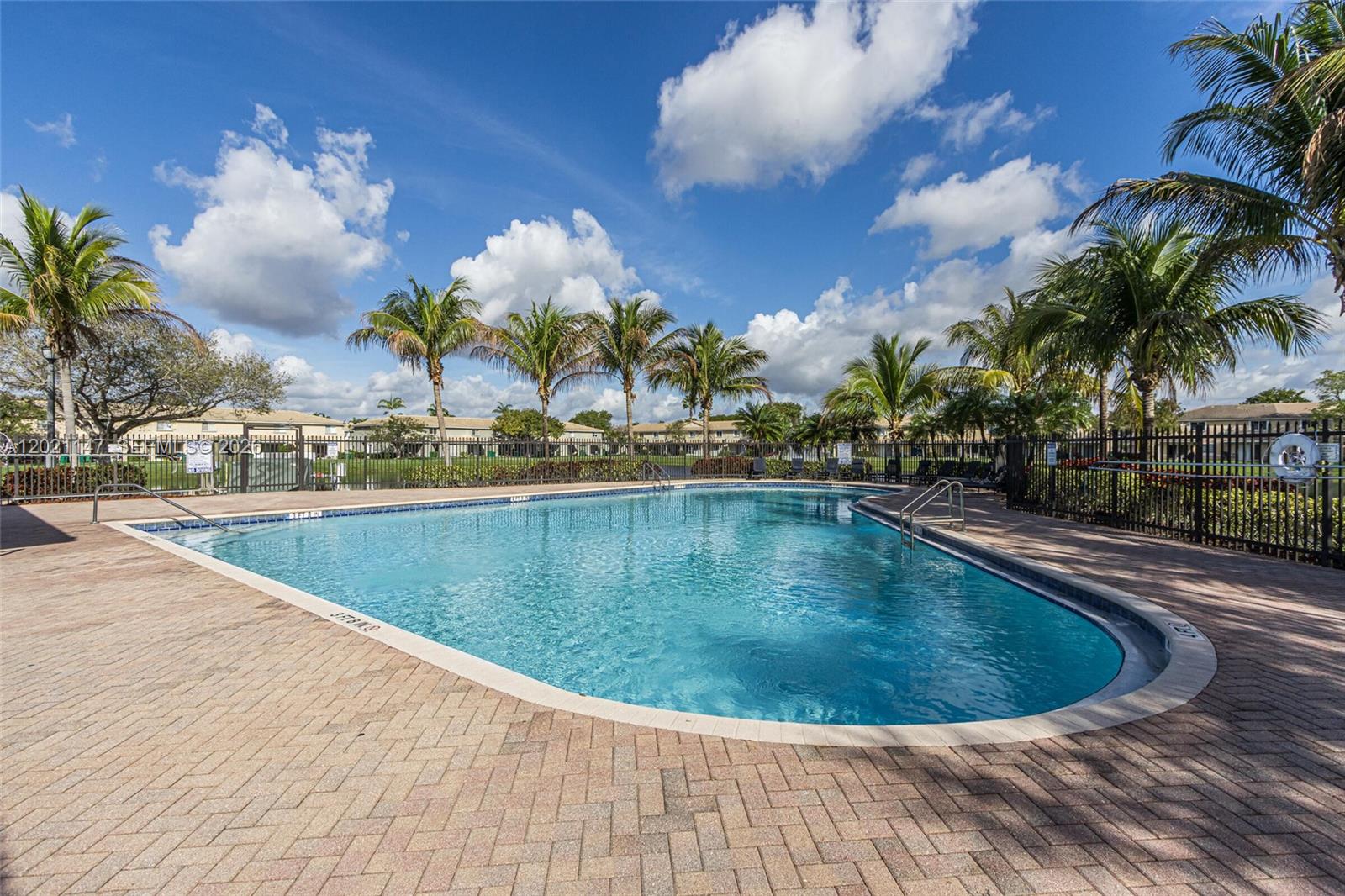 5930 Abbey Road Tamarac, FL 33321 - Photo 25 of 26 a view of a swimming pool with a lounge chairs