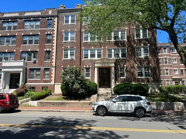 a car parked in front of a white building