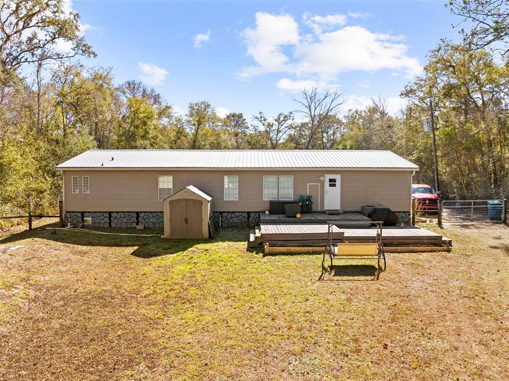 17095 Frankfort Road Brooksville, FL 34601 - Photo 11 of 42 a view of a house with swimming pool and sitting area