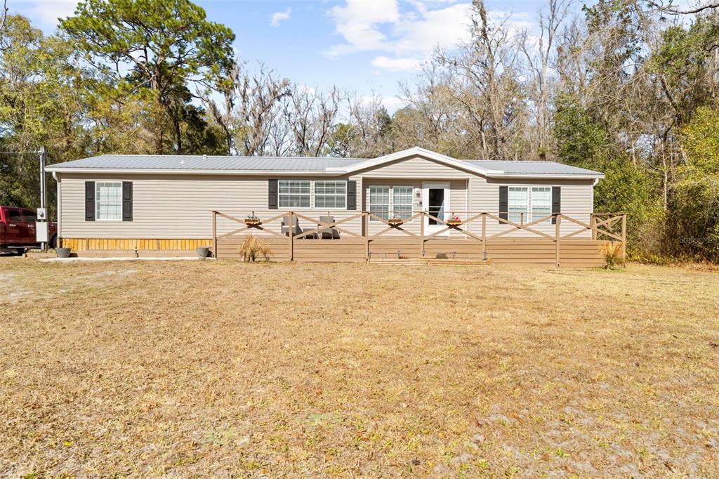 17095 Frankfort Road Brooksville, FL 34601 - Photo 13 of 42 a front view of a house with yard patio and garage