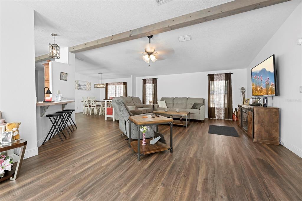 17095 Frankfort Road Brooksville, FL 34601 - Photo 16 of 42 a living room with furniture and a wooden floor