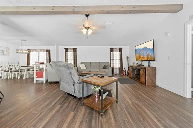 a living room with furniture a couch and a chandelier