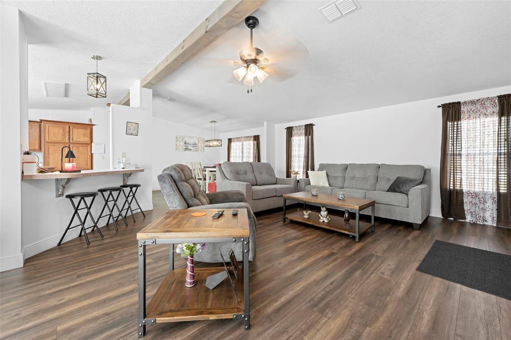 17095 Frankfort Road Brooksville, FL 34601 - Photo 18 of 42 a living room with furniture and wooden floor