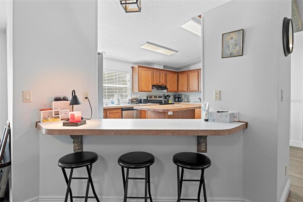 17095 Frankfort Road Brooksville, FL 34601 - Photo 21 of 42 a kitchen with stainless steel appliances a table and chairs in it