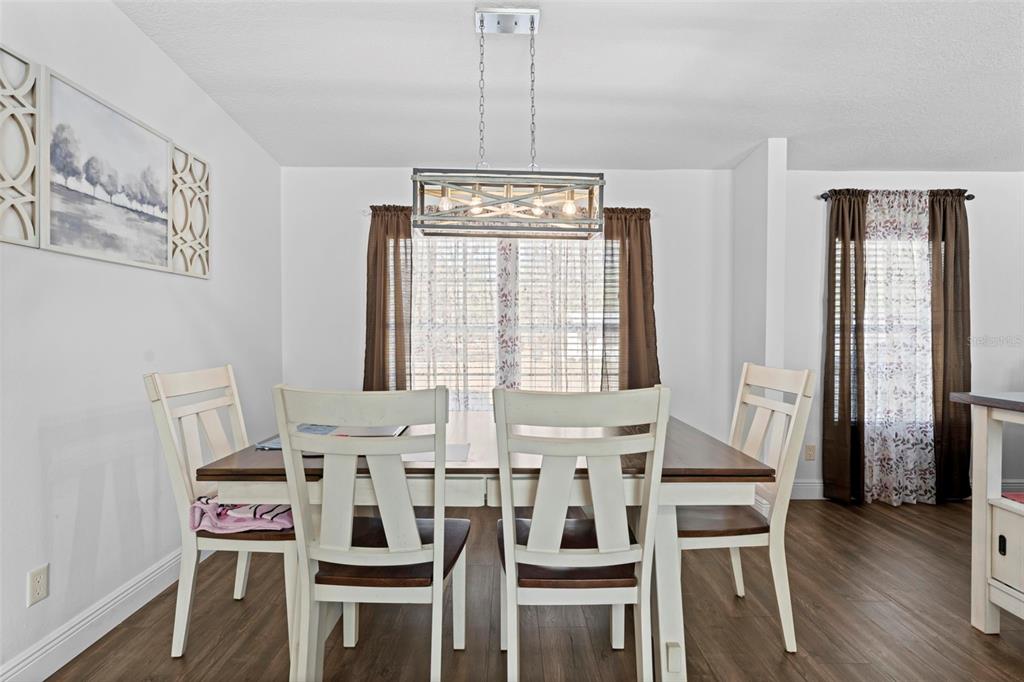 17095 Frankfort Road Brooksville, FL 34601 - Photo 24 of 42 a view of a dining room with furniture and wooden floor