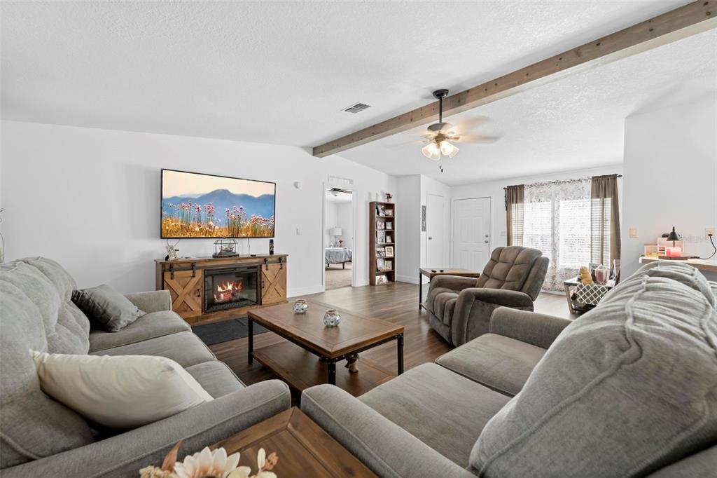 17095 Frankfort Road Brooksville, FL 34601 - Photo 27 of 42 a living room with furniture ceiling fan and a rug