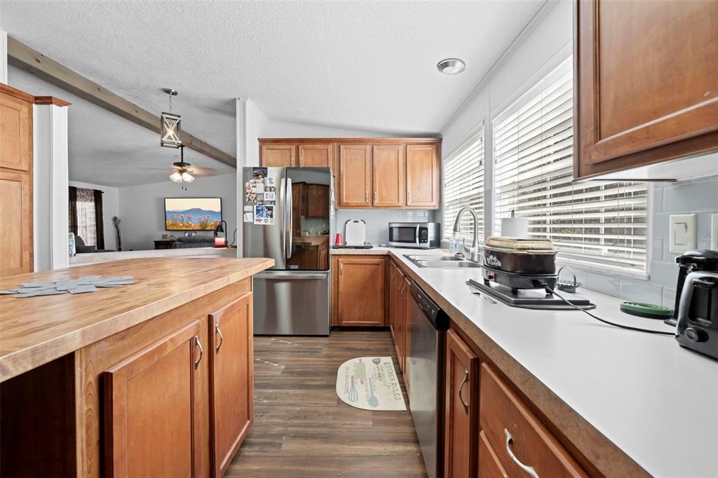 17095 Frankfort Road Brooksville, FL 34601 - Photo 30 of 42 a kitchen with a sink appliances cabinets and furniture