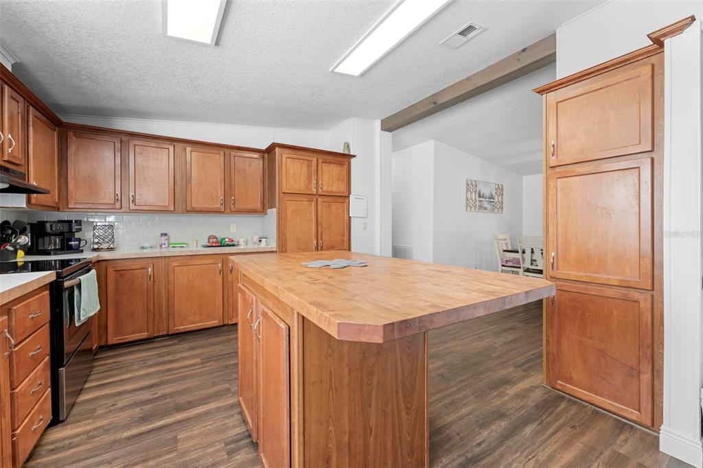 17095 Frankfort Road Brooksville, FL 34601 - Photo 31 of 42 a kitchen with stainless steel appliances granite countertop a sink refrigerator and cabinets