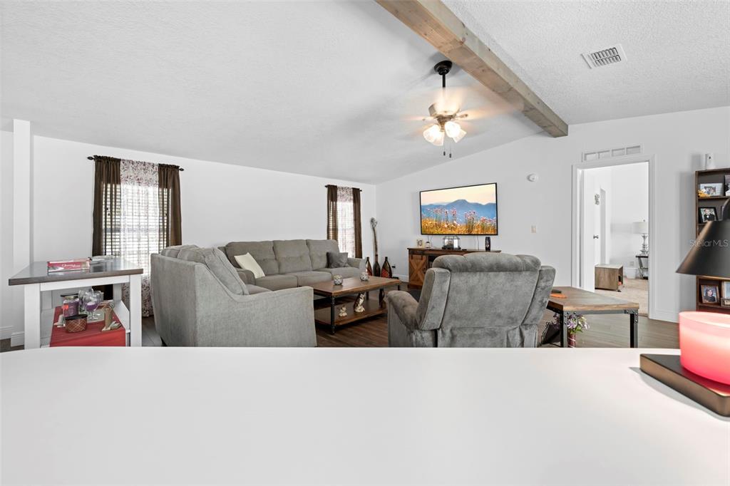 17095 Frankfort Road Brooksville, FL 34601 - Photo 33 of 42 a living room with furniture and a flat screen tv