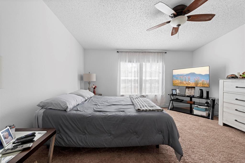 17095 Frankfort Road Brooksville, FL 34601 - Photo 36 of 42 a bedroom with a bed and a chandelier