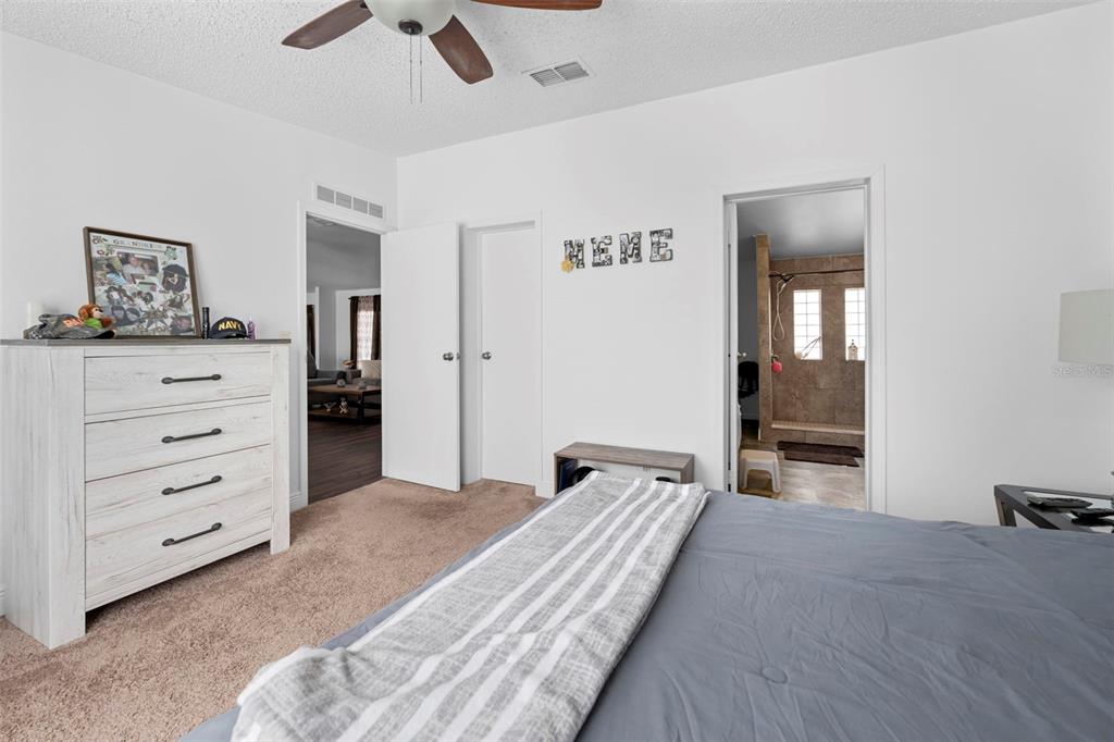 17095 Frankfort Road Brooksville, FL 34601 - Photo 37 of 42 a bedroom with a bed and a chandelier