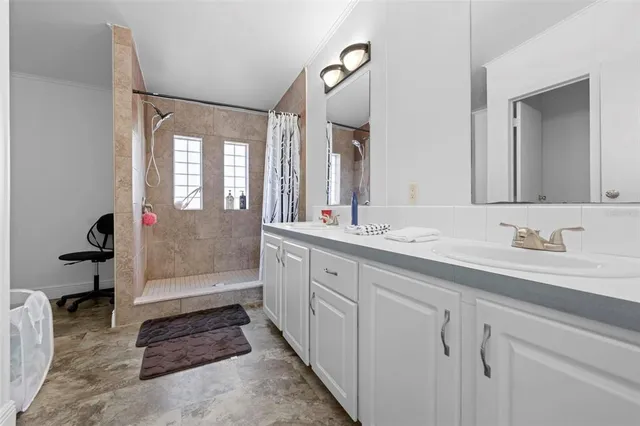 a bathroom with a sink toilet vanity and shower