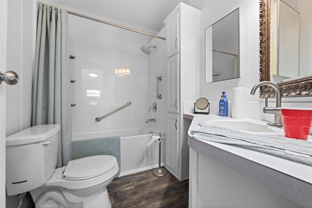 17095 Frankfort Road Brooksville, FL 34601 - Photo 40 of 42 a bathroom with a sink toilet vanity and shower