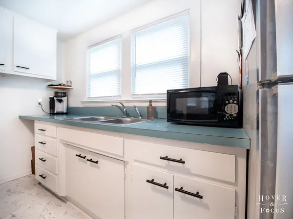 a kitchen with appliances cabinets and a window