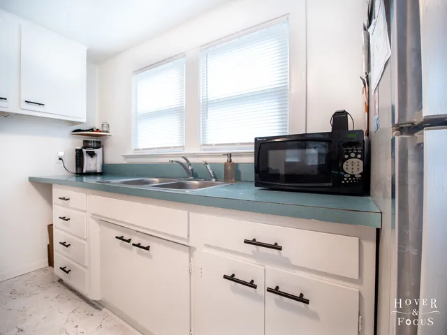 a kitchen with appliances cabinets and a window