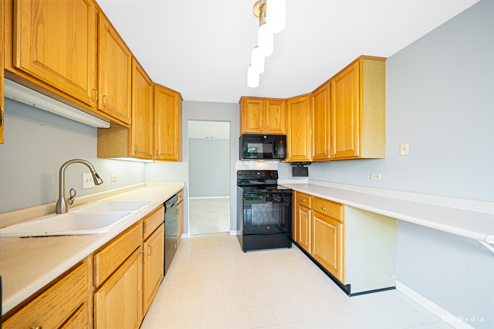 1477 South County Farm Road, Unit 23F Wheaton, IL 60189 - Photo 12 of 27 a kitchen with stainless steel appliances granite countertop a sink a stove and a refrigerator