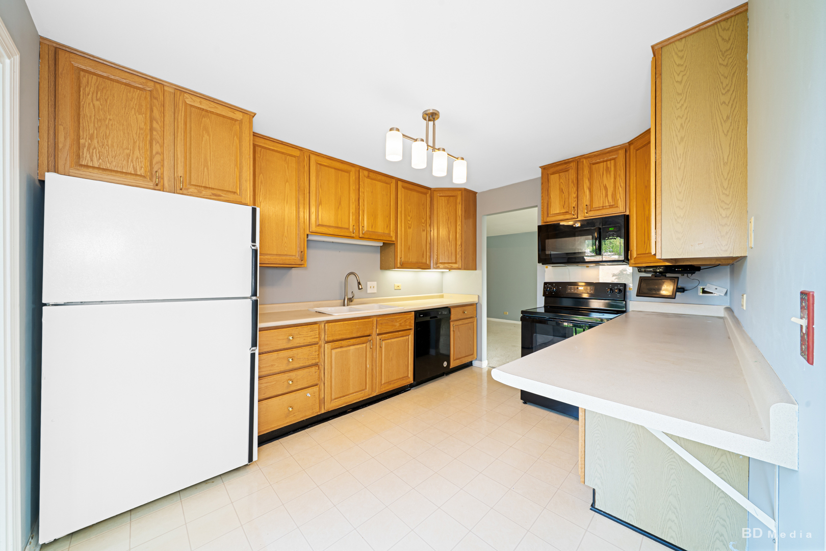 1477 South County Farm Road, Unit 23F Wheaton, IL 60189 - Photo 13 of 27 a kitchen with stainless steel appliances a refrigerator sink and microwave