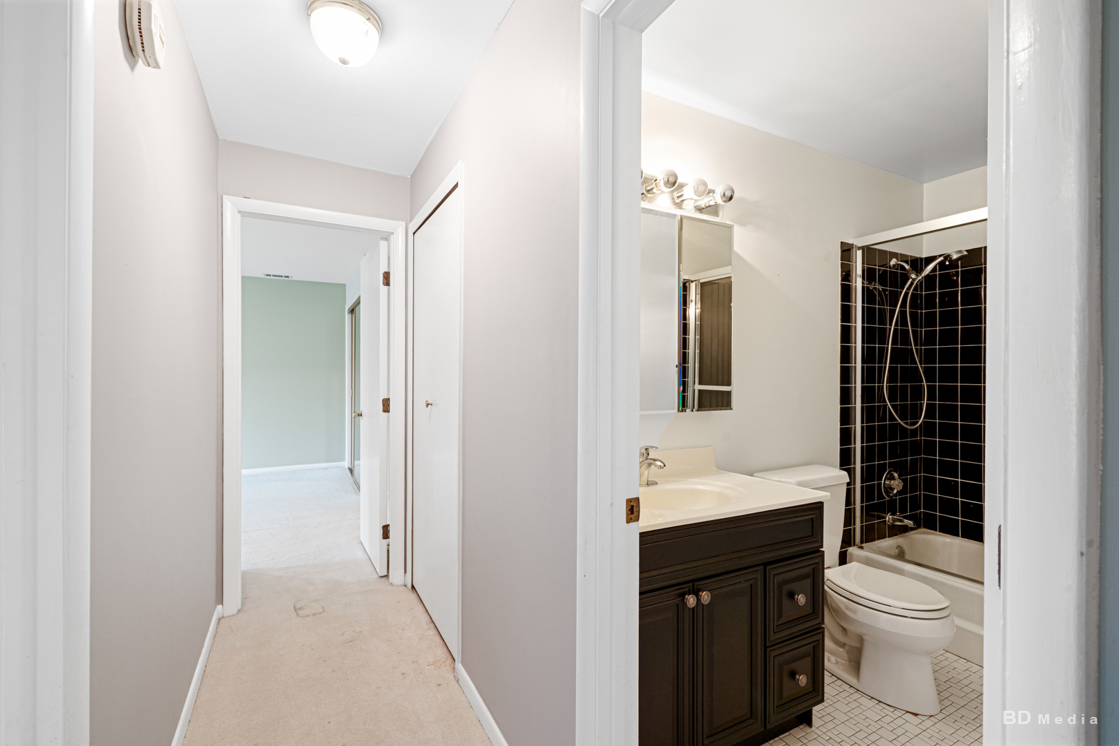 1477 South County Farm Road, Unit 23F Wheaton, IL 60189 - Photo 21 of 27 a bathroom with a sink a toilet and shower