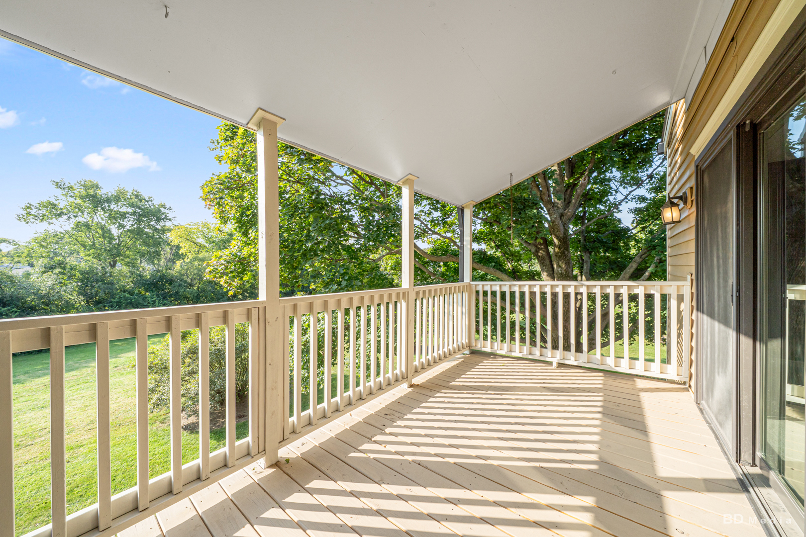 1477 South County Farm Road, Unit 23F Wheaton, IL 60189 - Photo 7 of 27 a view of a balcony with floor to ceiling windows with wooden floor