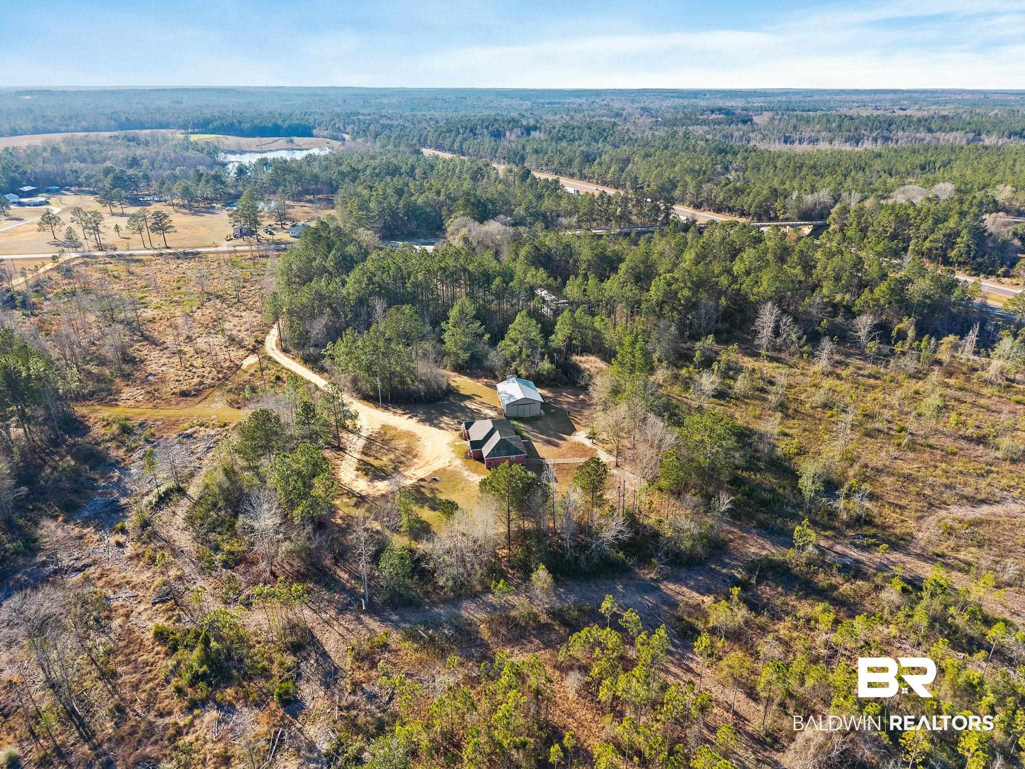 55750 Lottie Road Perdido, AL 36562 - Photo 14 of 84 Aerial view of property and surrounding area with a forest