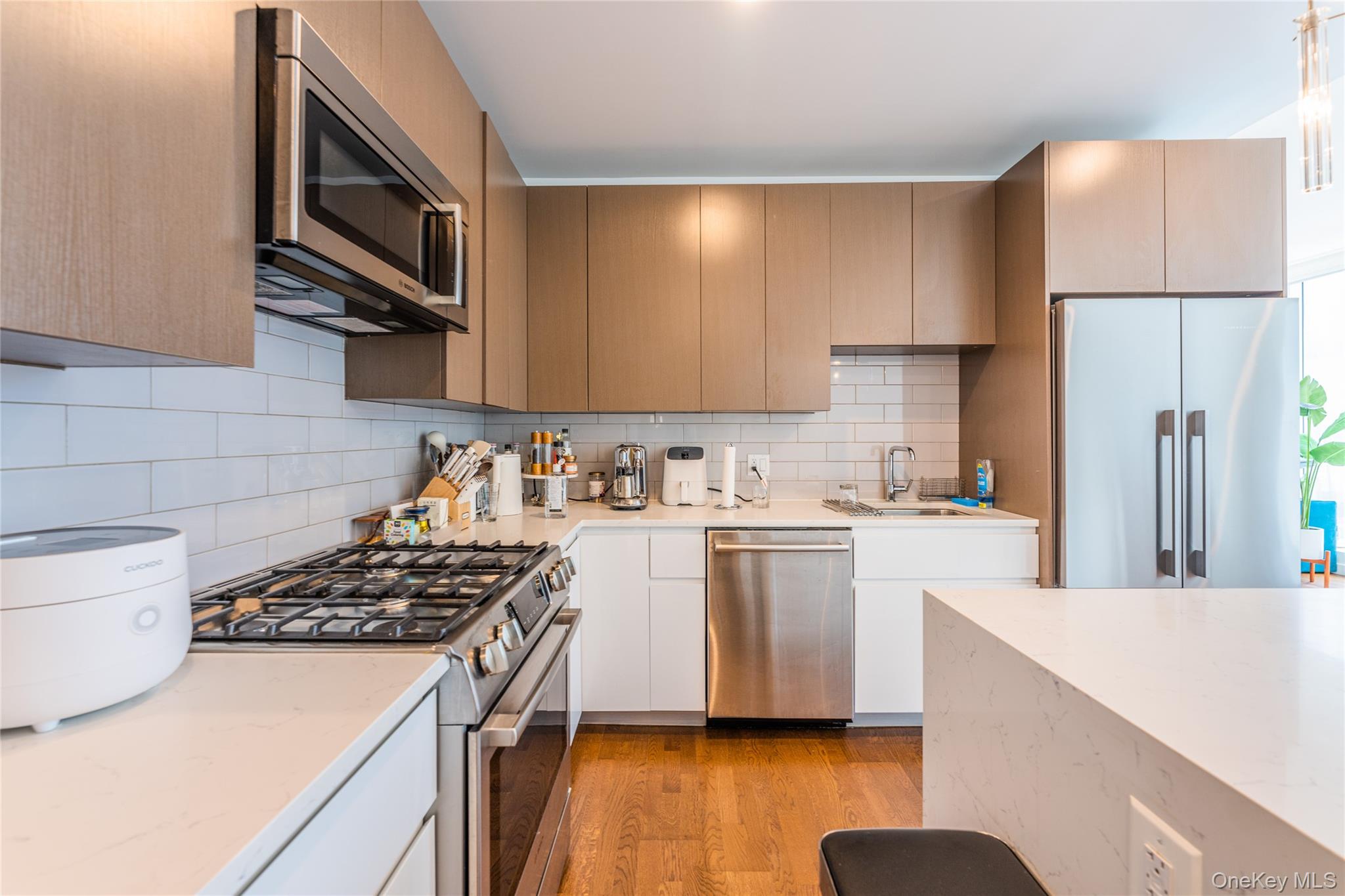 27-17 42nd Road, Unit 7E Queens, NY 11101 - Photo 11 of 42 a kitchen with a sink stove and refrigerator